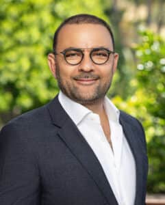 headshot of Tigran Martinian on a green background