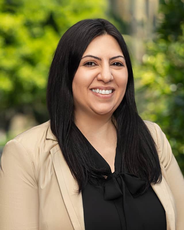 headshot of Sevana Vartazarian with a green background