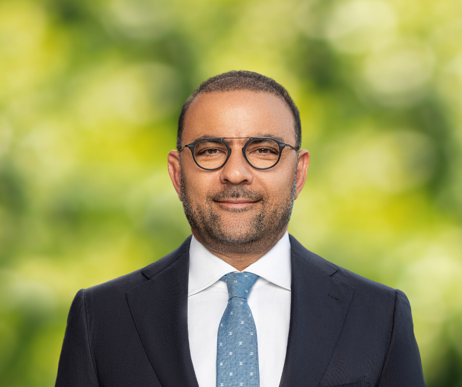 headshot of Tigran Martinian on a green background